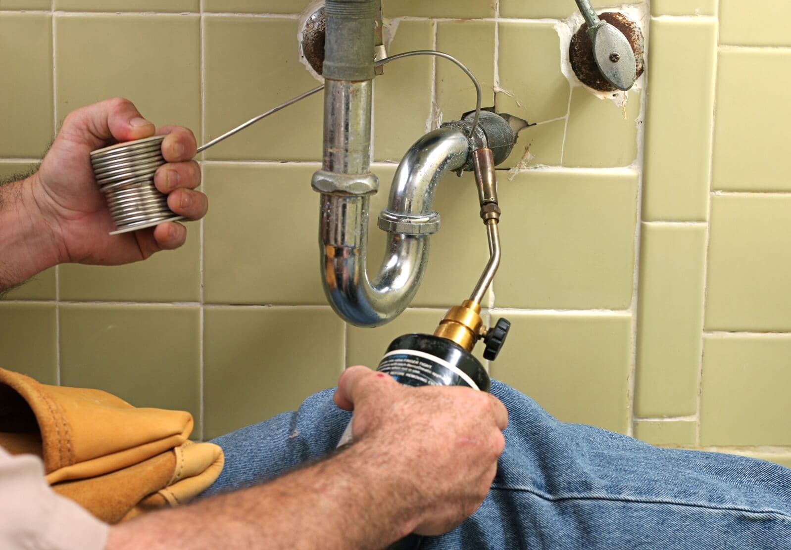 Plumber sweat welding copper pipe in Broward