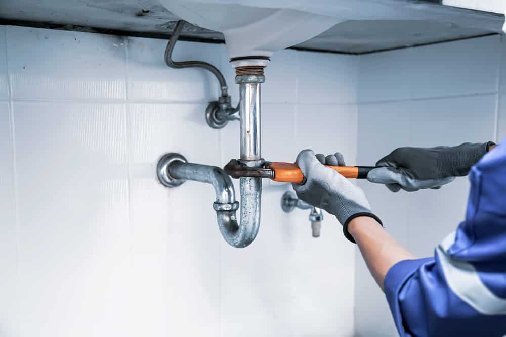 Fixing a severe plumbing blockage using professional tools